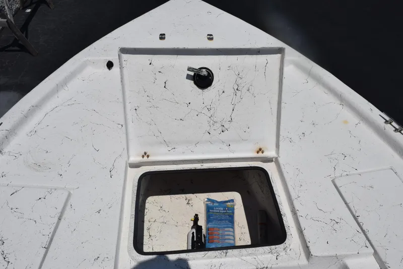 Slide: The Image of 2013 Blazer Bay 2170 boat compartment with open hatch, showing interior storage space. - 14