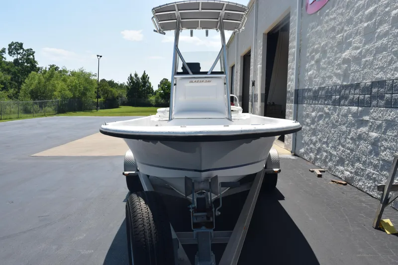 Slide: The Image of 2013 Blazer Bay 2170 boat on trailer, parked outside a building. - 3