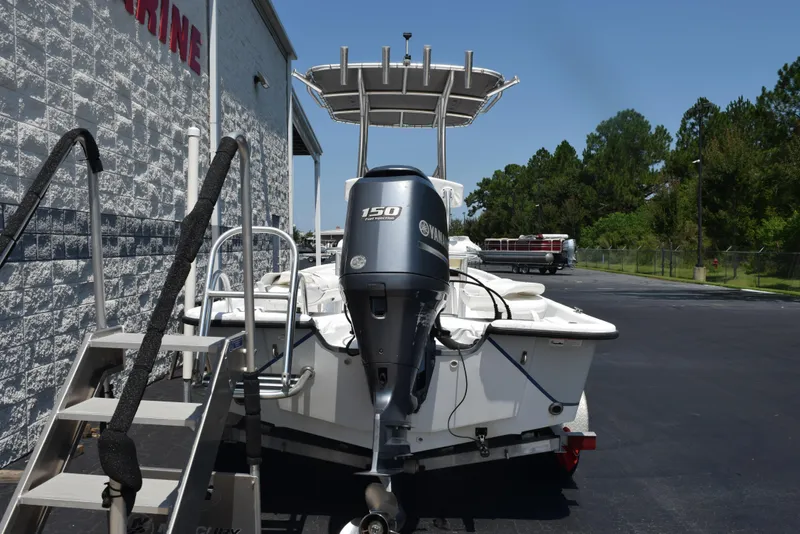 Slide: The Image of 2013 Blazer Bay 2170 boat with Yamaha 150 engine, parked near a building. - 5