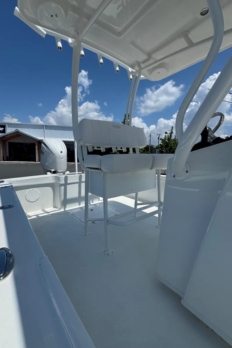 Slide: The Image of 2026 Pair Customs 21 Center Console MV boat interior with seating and console, under clear sky. - 3