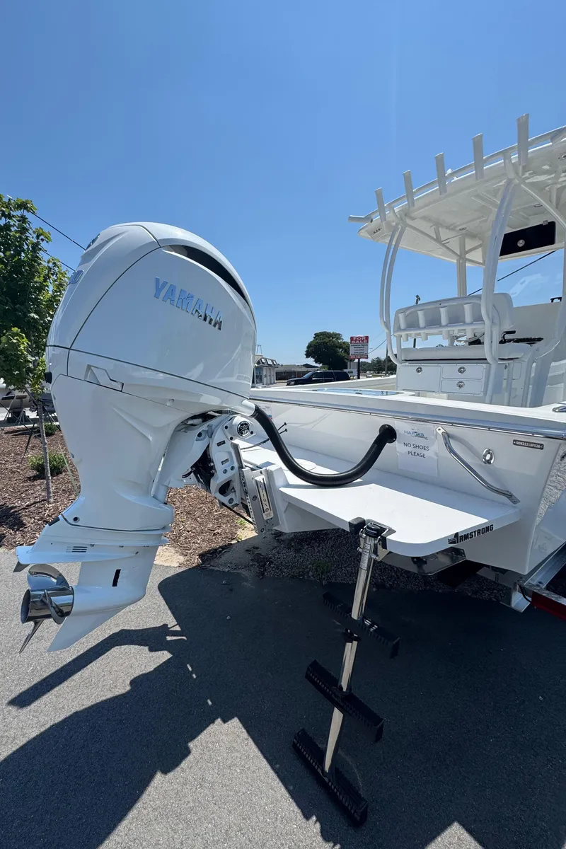 Slide: The Image of 2026 Pair Customs 21 Center Console MV with Yamaha outboard motor, docked under clear sky. - 4