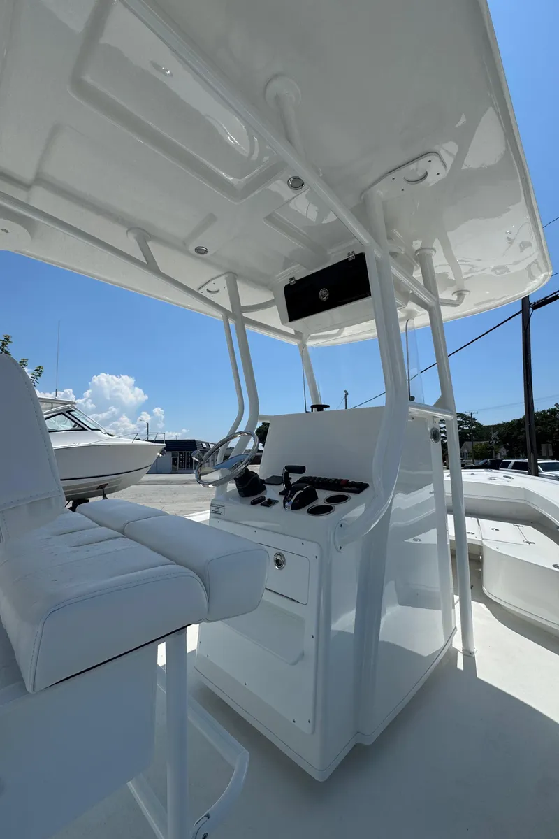 Slide: The Image of 2026 Pair Customs 21 Center Console MV boat interior with steering console and seating. - 5
