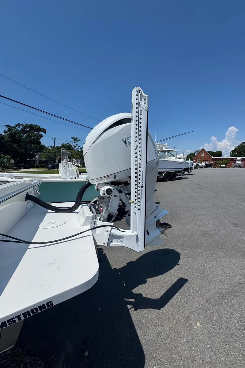 Slide: The Image of 2026 Pair Customs 21 Center Console MV boat with outboard motor in a parking lot. - 7