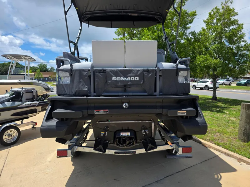 Slide: The Image of 2025 Sea-Doo Switch Compact Sport boat on trailer, rear view, parked outdoors. - 4