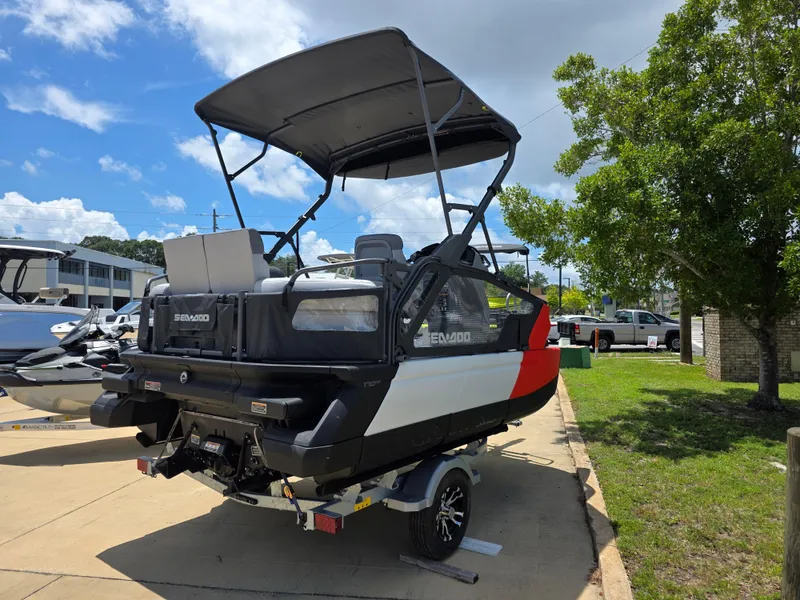 Slide: The Image of 2025 Sea-Doo Switch Compact Sport boat on trailer, parked outdoors under a clear sky. - 5
