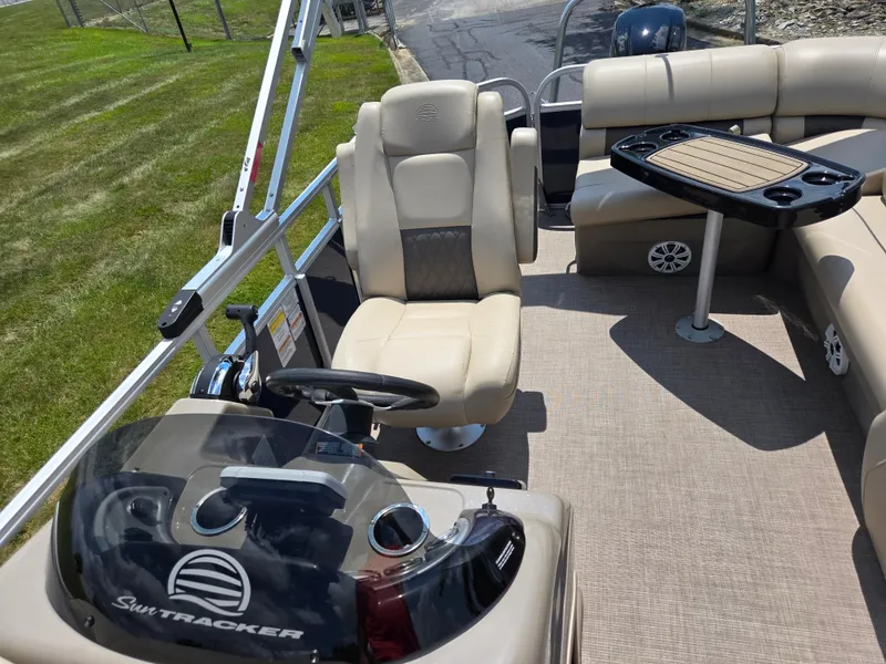 Slide: The Image of 2022 Sun Tracker Party Barge 20 DLX interior with seating and steering console. - 11