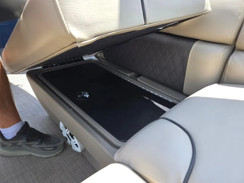 Slide: The Image of Open storage compartment under seat of 2022 Sun Tracker Party Barge 20 DLX. - 13