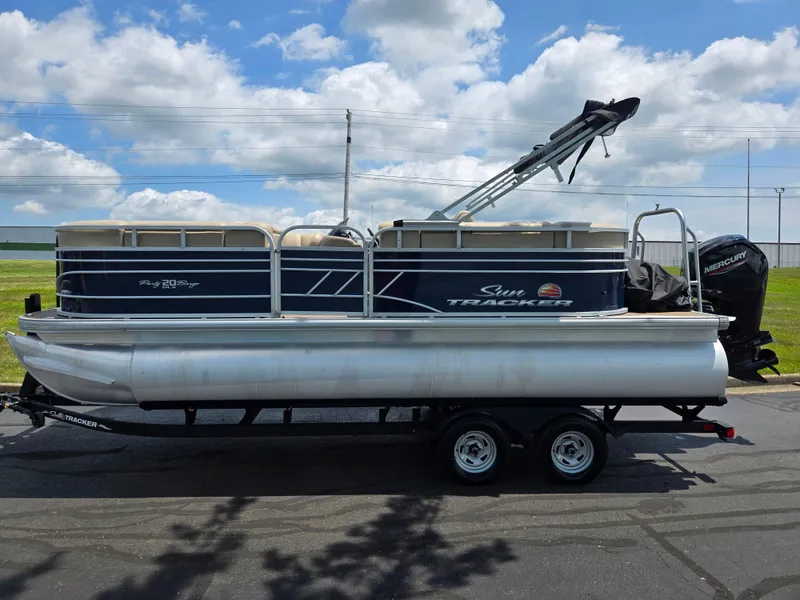 Slide: The Image of 2022 Sun Tracker Party Barge 20 DLX pontoon boat on trailer, parked outdoors. - 4