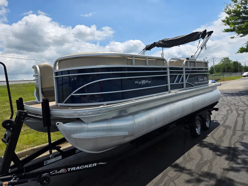 Slide: The Image of 2022 Sun Tracker Party Barge 20 DLX pontoon boat on trailer, parked outdoors. - 5