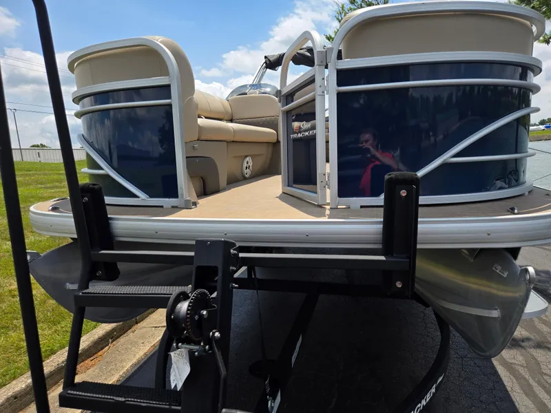 Slide: The Image of 2022 Sun Tracker Party Barge 20 DLX pontoon boat on trailer, sunny day. - 6