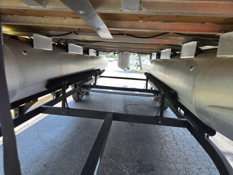 Slide: The Image of Underneath view of 2022 Sun Tracker Party Barge 20 DLX pontoon boat on trailer. - 7