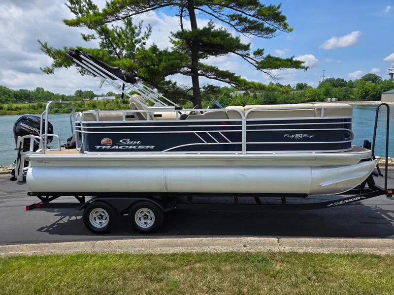 Slide: The Image of 2022 Sun Tracker Party Barge 20 DLX pontoon boat on trailer by a lake. - 9
