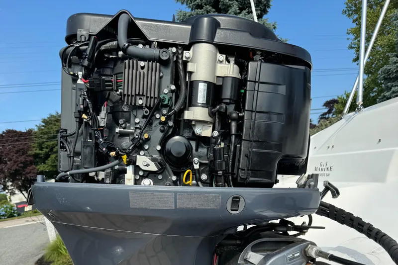 Slide: The Image of Open engine of a 2014 NauticStar 203SC Sport Deck boat, showcasing mechanical components. - 10