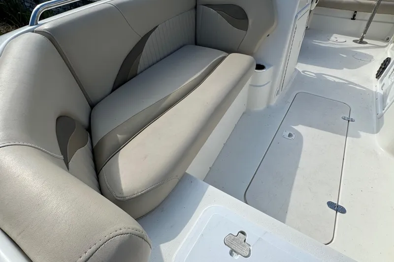 Slide: The Image of 2014 NauticStar 203SC Sport Deck boat interior with beige seating and storage compartments. - 7