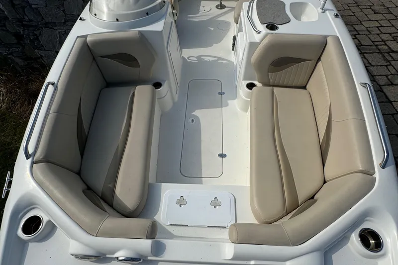 Slide: The Image of 2014 NauticStar 203SC Sport Deck boat interior with beige seating and cup holders. - 8