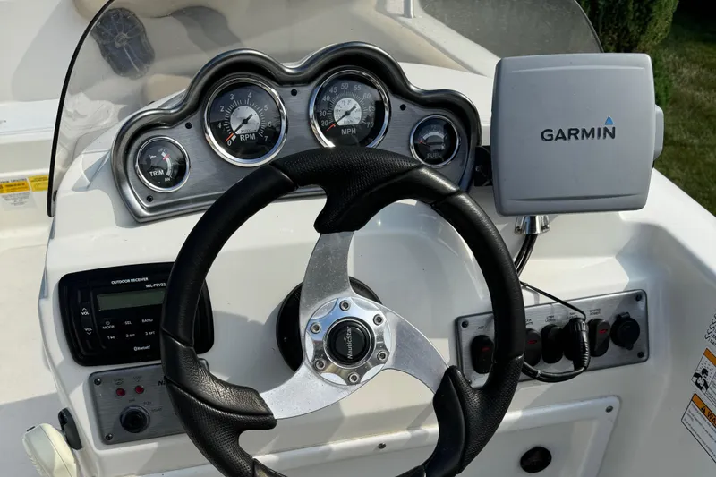 Slide: The Image of 2014 NauticStar 203SC Sport Deck dashboard with Garmin GPS and control gauges. - 9