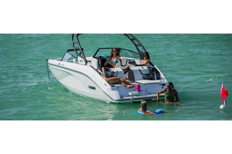 Slide: The Image of 2025 Yamaha Boats 222S on water with people relaxing and swimming nearby. - 11