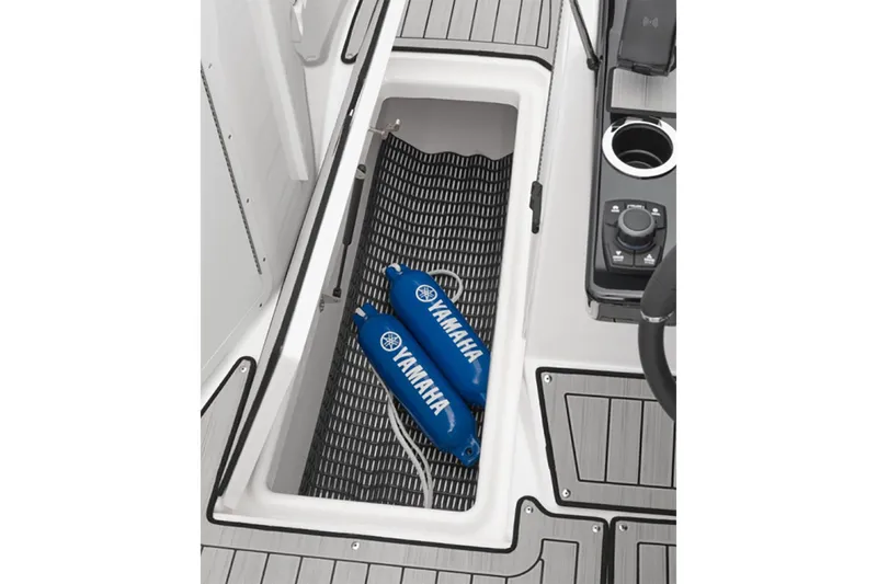 Slide: The Image of 2025 Yamaha Boats 222S storage compartment with blue Yamaha fenders and control panel. - 6