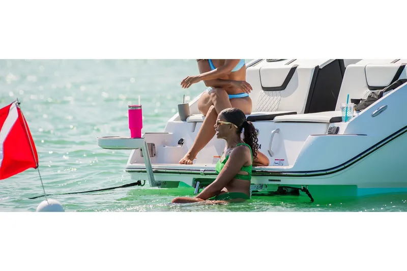 Slide: The Image of 2025 Yamaha Boats 222S with people enjoying water activities. - 7