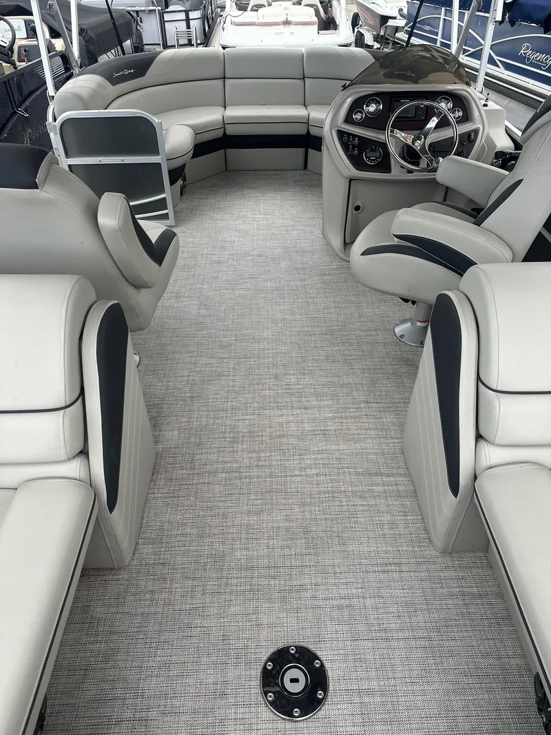 Slide: The Image of Interior of 2022 South Bay 222RS LE pontoon boat with plush seating and modern helm. - 4