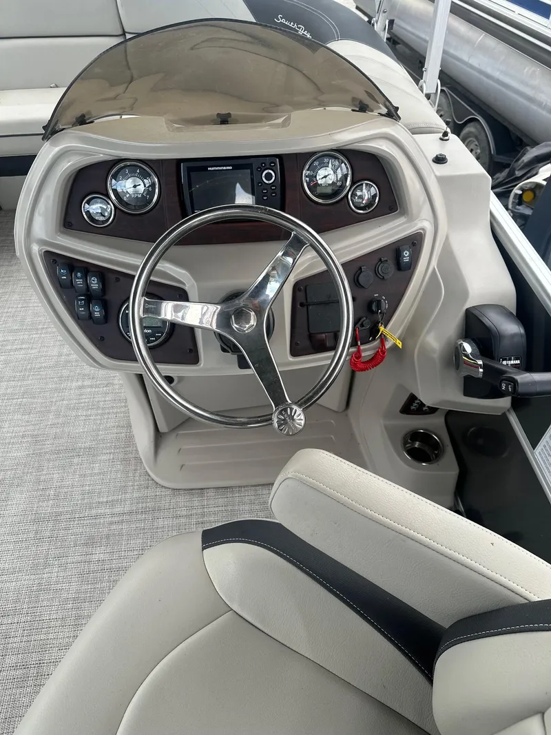 Slide: The Image of Captain's helm of 2022 South Bay 222RS LE pontoon boat with steering wheel and controls. - 5