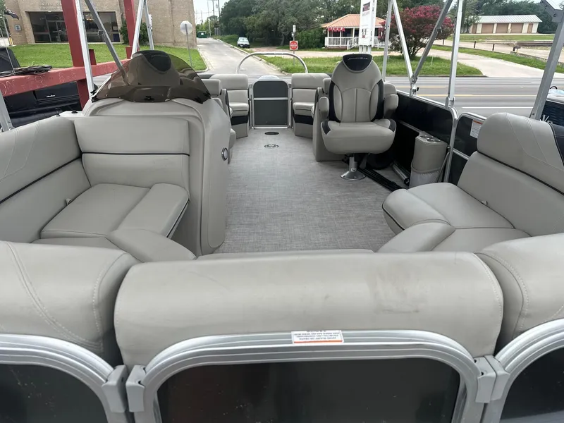 Slide: The Image of 2022 South Bay 222RS LE pontoon boat interior with gray seating and captain's chair. - 6
