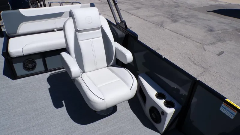 Slide: The Image of Luxurious seating on 2025 Godfrey Sweetwater 2486 SFLC pontoon boat, featuring cup holders and speakers. - 13