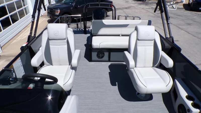 Slide: The Image of 2025 Godfrey Sweetwater 2486 SFLC boat interior with white seating and modern design. - 14