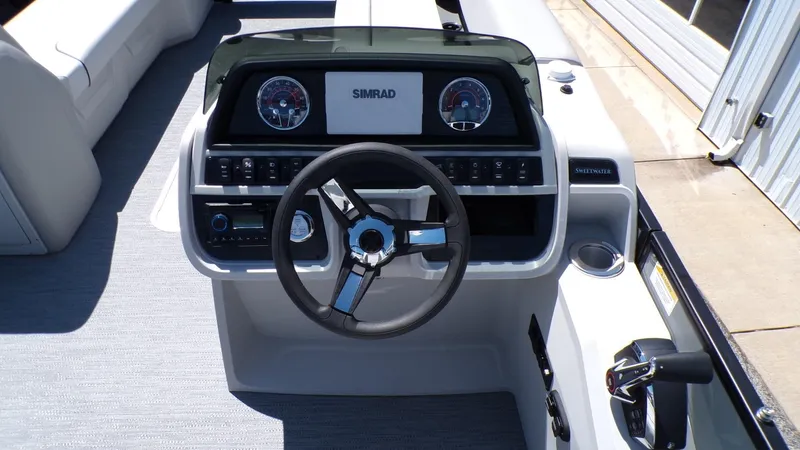 Slide: The Image of 2025 Godfrey Sweetwater 2486 SFLC boat dashboard with steering wheel and controls. - 16