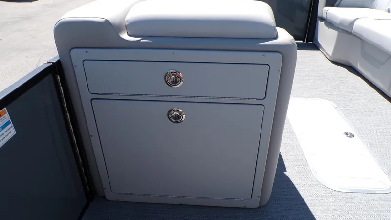 Slide: The Image of 2025 Godfrey Sweetwater 2486 SFLC boat interior with storage compartment and seating. - 18