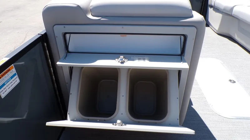 Slide: The Image of Storage compartment on 2025 Godfrey Sweetwater 2486 SFLC boat, featuring dual bins. - 19