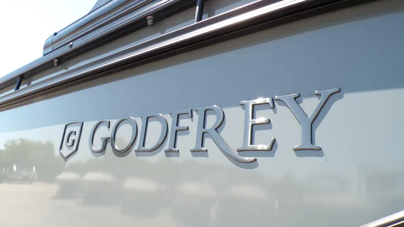 Slide: The Image of Close-up of Godfrey Sweetwater 2486 SFLC 2025 logo on boat exterior. - 23