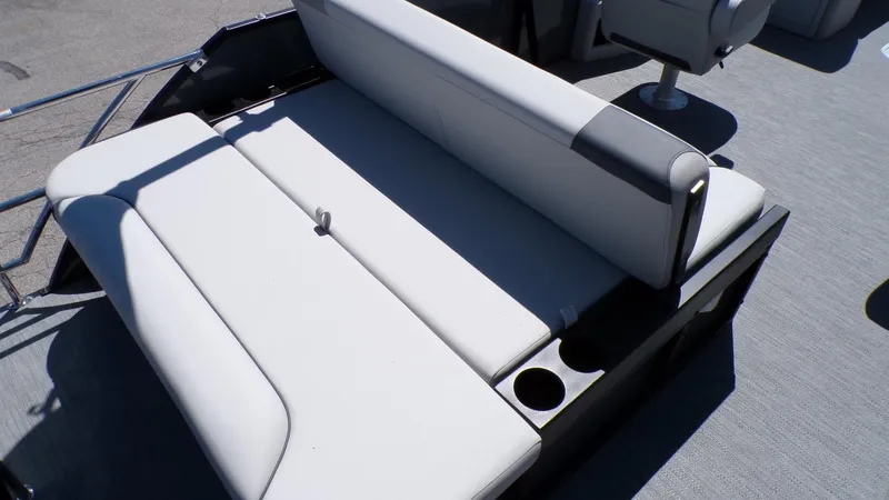 Slide: The Image of 2025 Godfrey Sweetwater 2486 SFLC boat seating with cup holders, gray upholstery. - 7