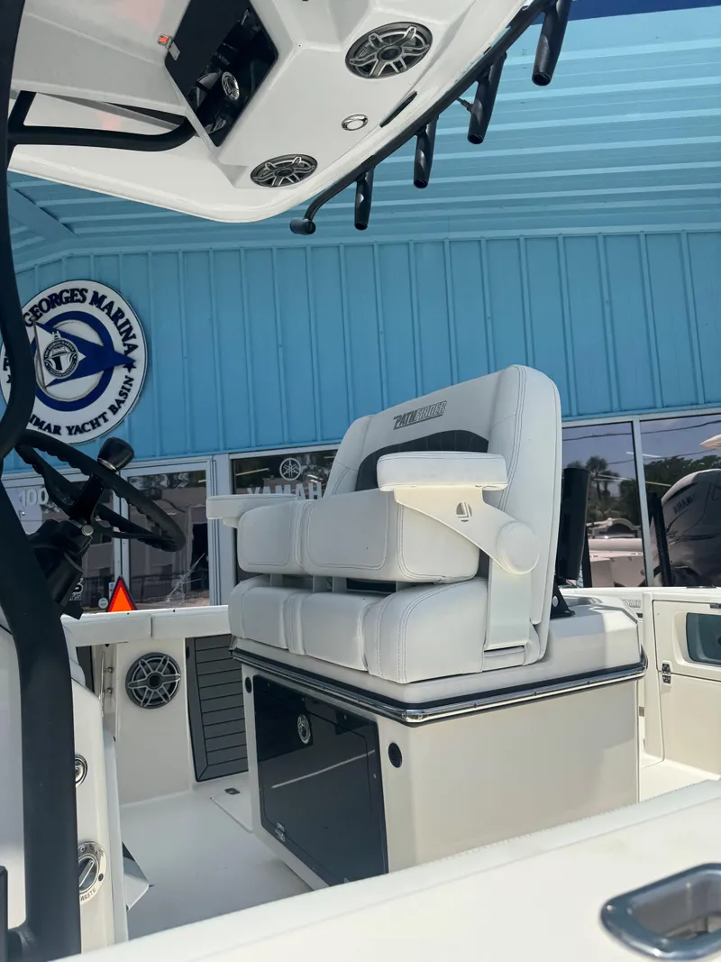 Slide: The Image of 2023 Pathfinder 2700 Open boat interior with white seating at marina. - 4