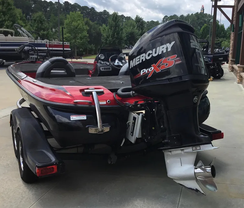 Slide: The Image of 2013 Nitro Z8 boat with Mercury Pro XS engine, parked outdoors. - 11