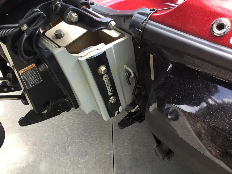 Slide: The Image of 2013 Nitro Z8 boat motor mount with hydraulic components and warning label. - 13