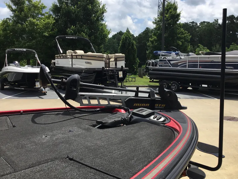 Slide: The Image of 2013 Nitro Z8 boat with Minn Kota trolling motor, surrounded by other boats in a parking area. - 5