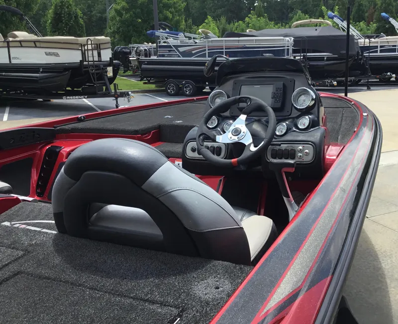Slide: The Image of 2013 Nitro Z8 boat interior with steering wheel and dashboard, surrounded by other boats. - 9