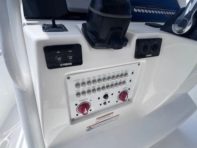 Slide: The Image of Control panel of a 2017 Edgewater 262CC boat with Yamaha switches and dials. - 12