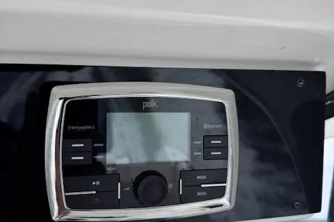 Slide: The Image of Polk Bluetooth stereo system on 2017 Edgewater 262CC boat dashboard. - 16