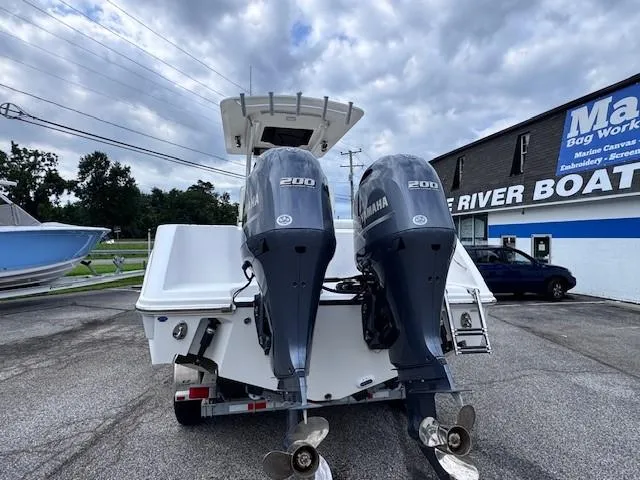 Slide: The Image of 2017 Edgewater 262CC boat with twin Yamaha 200 engines, parked outdoors. - 4