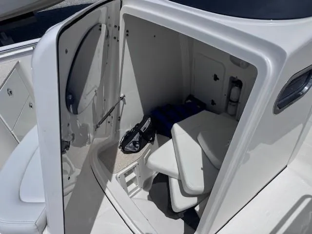 Slide: The Image of 2017 Edgewater 262CC boat interior cabin with seating and storage. - 6