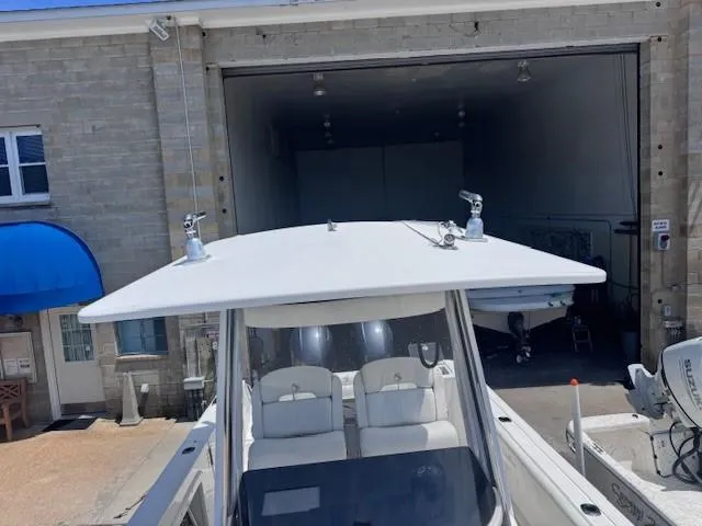 Slide: The Image of 2017 Edgewater 262CC boat near a garage entrance, showcasing its sleek design. - 9