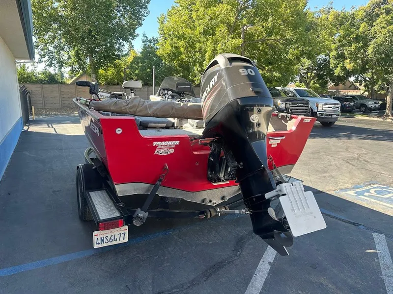 Slide: The Image of 2013 Tracker Pro Guide V-175 SC boat with Mercury 90 engine, parked outdoors. - 10