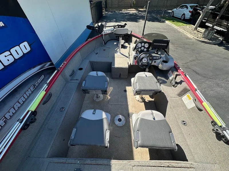 Slide: The Image of 2013 Tracker Pro Guide V-175 SC boat interior with seating and control panel. - 11