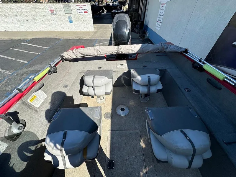 Slide: The Image of 2013 Tracker Pro Guide V-175 SC boat interior with seating and fishing rod holders. - 13