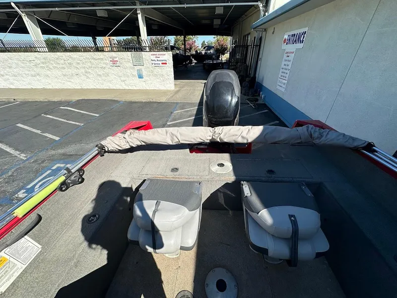 Slide: The Image of 2013 Tracker Pro Guide V-175 SC boat interior with seats and covered equipment. - 14