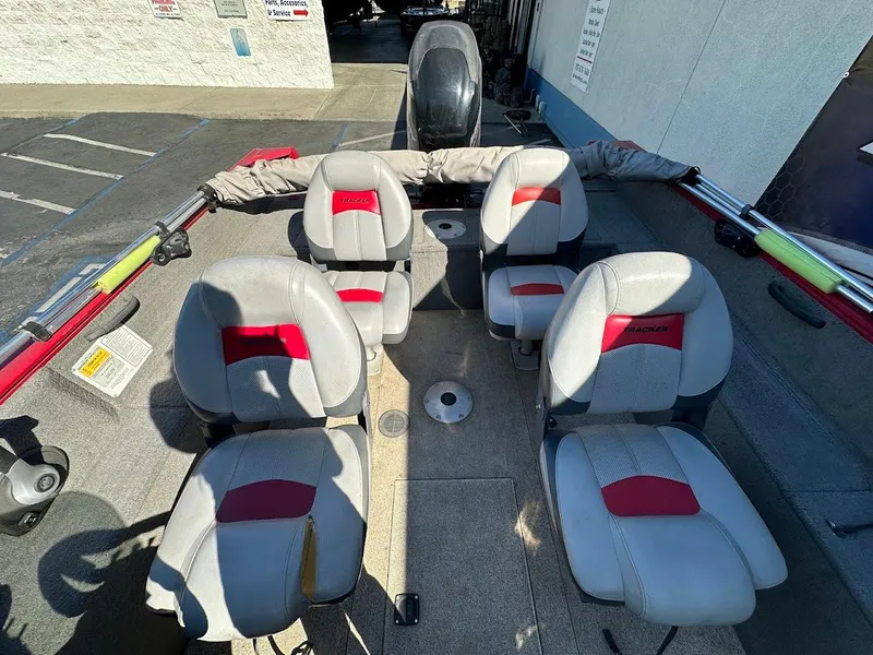 Slide: The Image of 2013 Tracker Pro Guide V-175 SC boat interior with four seats and fishing rod holders. - 16