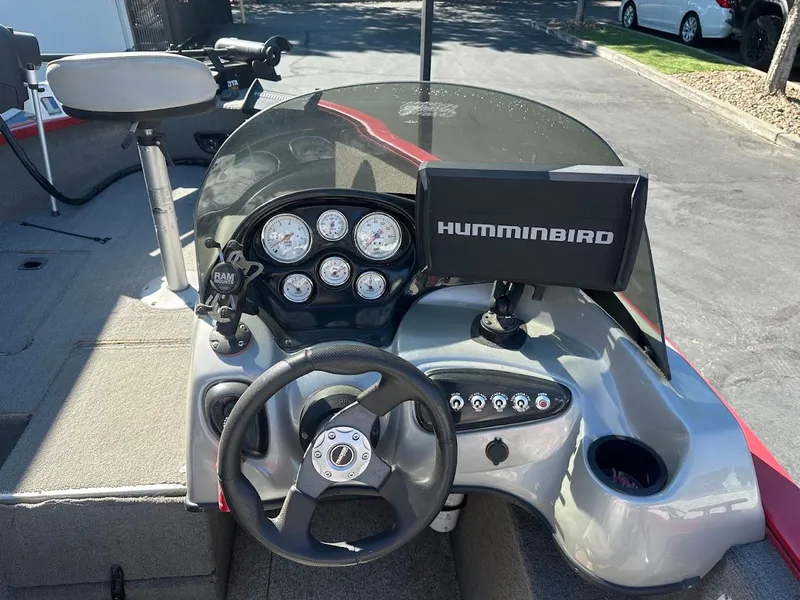 Slide: The Image of 2013 Tracker Pro Guide V-175 SC boat dashboard with Humminbird fish finder and steering wheel. - 18