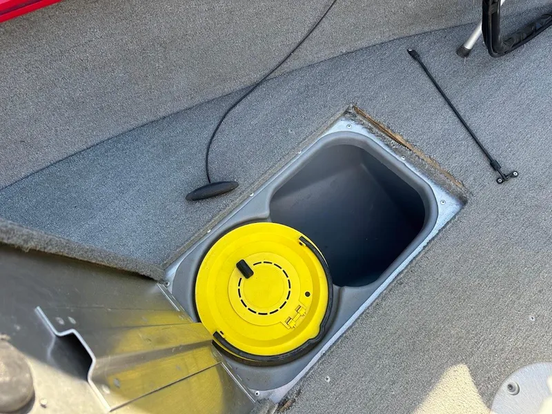 Slide: The Image of 2013 Tracker Pro Guide V-175 SC boat interior with storage compartment and yellow lid. - 29